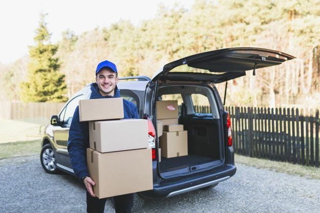 Courier unloading packages from a delivery van